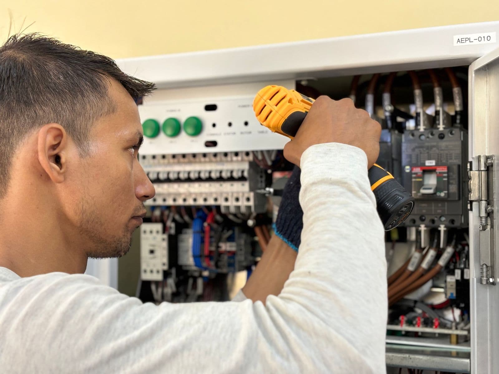 Electrician inspecting wiring inside an electrical panel