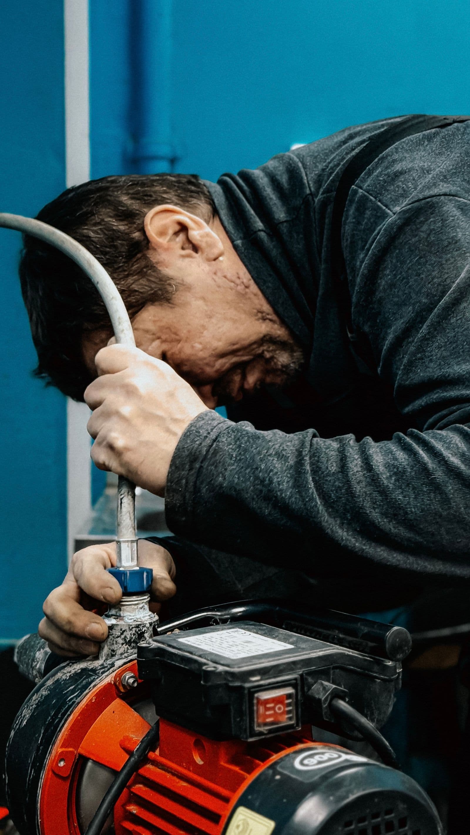 Technician repairing an electric water pump