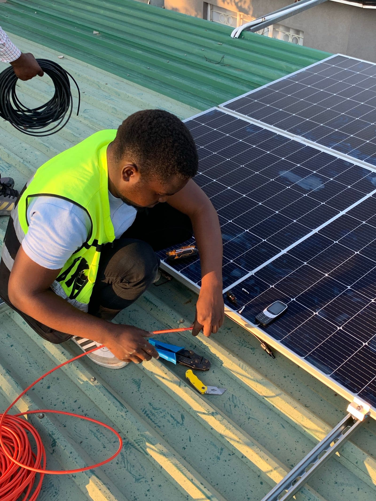 Technician installing solar panels on a rooftop
